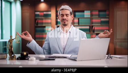 Focused Lawyer Pauses At Workspace For Stress Relief And Mental Clarity Stock Photo