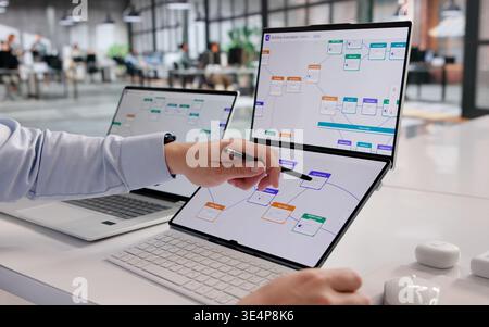 Hispanic Professional Enhances Business Process Automation Using Laptop Technology Stock Photo