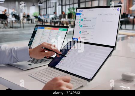 Hispanic Businessman Reviews Messages On Laptop At Office Desk, Using Digital Tools For Corporate Communication Stock Photo