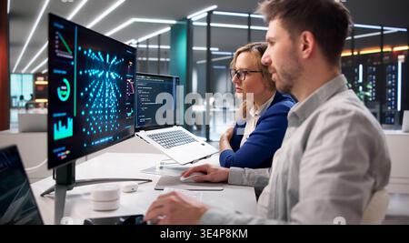 AI Specialist Oversees Real-Time Server Inference Operations In Data Center Environment Using Laptops Stock Photo