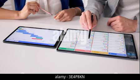 Project Manager Evaluates Schedule And Updates Event Planning Gantt Chart Stock Photo
