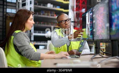 Two Engineers, A Man And Woman, Design Rocket Engines Using 3D CAD Software On Desktop Computers, Working In Aerospace Stock Photo