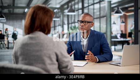Two Young Recruiters Shaking Hands In Office After Successful Hiring Meeting. Stock Photo