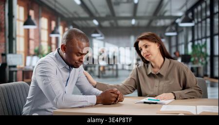 Young African American Professional Feeling Stressed, Upset, And Overwhelmed At Work. A Young African American Woman Stock Photo