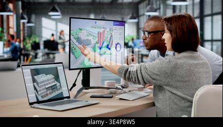 Woman Engineer Uses BIM And GIS Software For Urban Property Mapping. Two Professionals Inspect Real Estate Sites Stock Photo