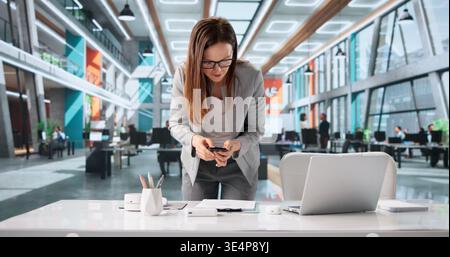 Office Worker Secretly Takes Confidential Business Papers During Work Time Stock Photo