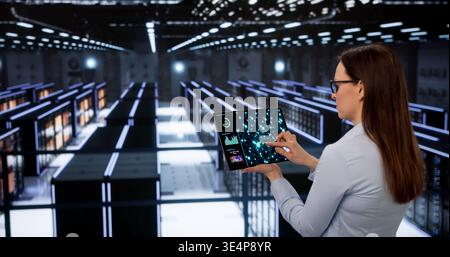 Female Engineer Oversees AI Training Processes In Secure Data Center Stock Photo