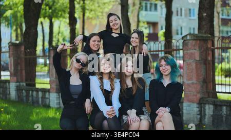 Happy teens having a great time together at school, smiling for a photo in the campus park Stock Photo