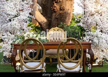 Elegant Rustic Wedding Altar Table and Chair Setup with Floral Decoration Stock Photo