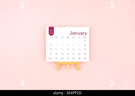 January 2027 calendar page with wooden easel on pink color background Stock  Photo - Alamy