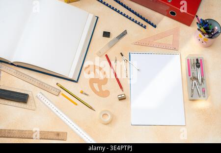 Top View Workspace with Blank Spiral Notebook Rulers and Engineering Drawing Instruments. Stock Photo