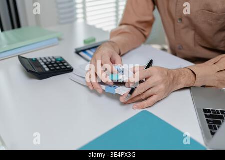 Close up of person organizing financial documents with clips on desk, representing paperwork management, accounting process, office organization, and Stock Photo