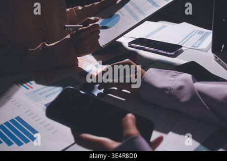 Above table with finance papers, graphs and big data during teamwork meeting with accounting or marketing team discussing budget, strategy or growth d Stock Photo
