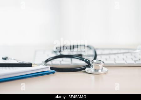 Stethoscope on smartphone with clipboard and pen on bright desk background, symbolizing telemedicine, digital healthcare records, online consultation Stock Photo