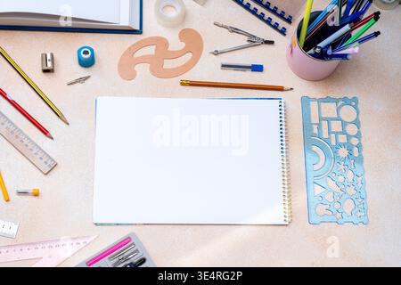 Art Supplies and Sketchbook on a Table. Desk top view copy space Stock Photo