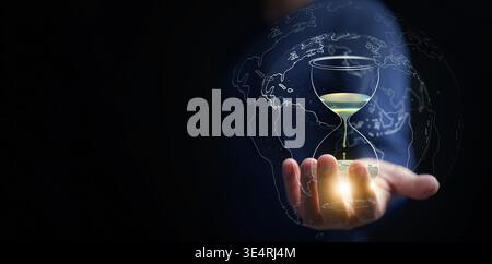 Global water scarcity and preservation concept. Hand holding digital hourglass with dripping water and global map overlay. Water crisis, environmental Stock Photo