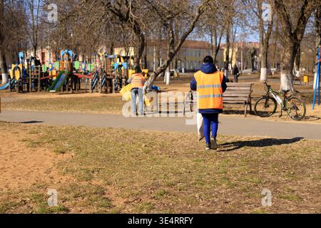 Municipal cleaning service workers collect rubbish bins set alight ...