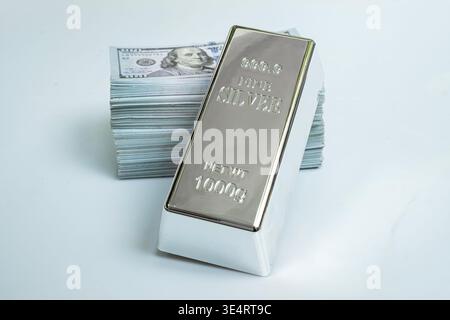 Fine silver and pile money banknote 100 USD on a gray background Stock Photo