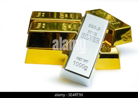 Fine silver bar leaned against a gold bars Stock Photo