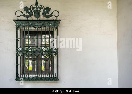 Window with iron bars and painted frame Stock Photo