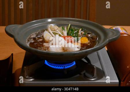 Seafood and vegetables roasted on a hot plate,Japan,Asia. Stock Photo