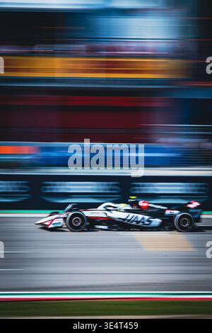 Haas Formula 1 car speeding on track with motion blur, capturing the high-speed essence of professional grand prix racing. Imola Stock Photo