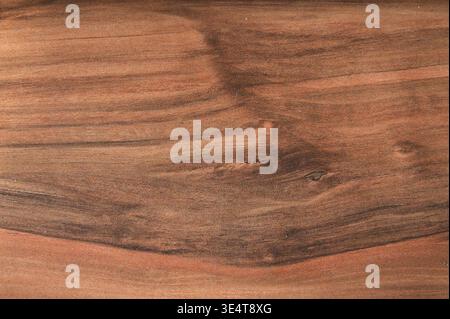 Rich brown wood grain texture with dark swirling patterns and natural lines Stock Photo
