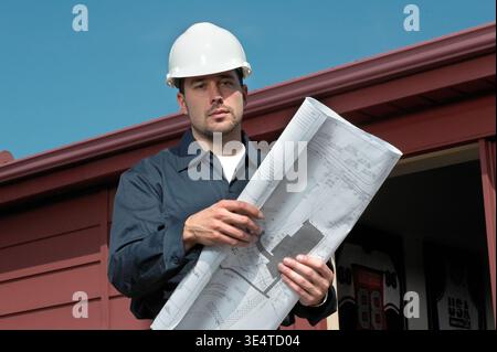 Engineering contactor supervisor with blueprints plans, USA Stock Photo