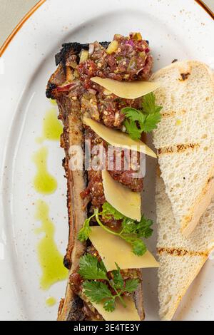 Bone marrow with beef tartare and bread slices Stock Photo