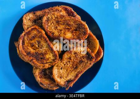Traditional Spanish torrijas from Madrid, made with bread, milk, eggs, cinnamon, and sugar. Stock Photo