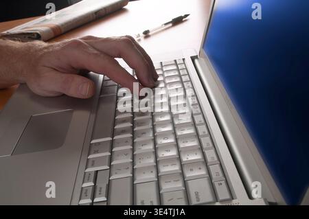 Man hand typing on laptop computer, USA Stock Photo