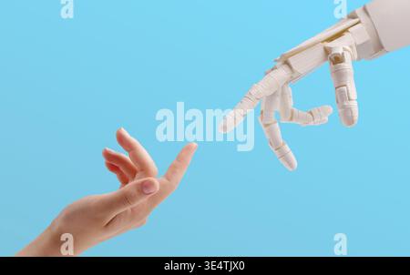 Woman hand and robot reaching to each other on blue Stock Photo