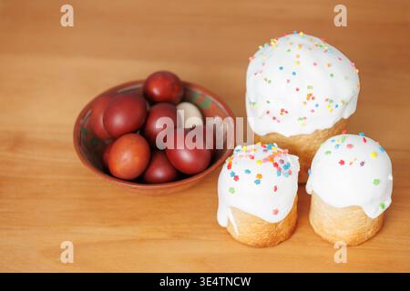 Holiday food background with Easter cake and painted eggs, minimal styling, natural tones, copy space. Stock Photo