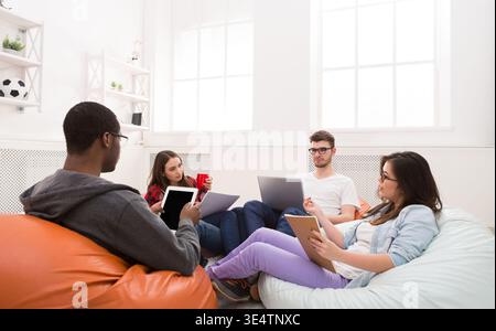 Colleagues share opinions during break, sitting indoors Stock Photo