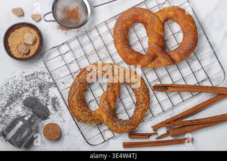 Food, Pretzel. Freshly baked pretzels with sugar, poppy seeds and cinnamon. Delicious homemade cakes and ingredients on the table. Selective focus, to Stock Photo