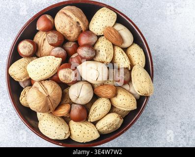 Food, Assorted nuts in the peel-almonds, hazelnuts, pecans, walnuts. Gourmet snack. Healthy food. Selective focus Stock Photo