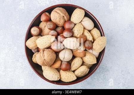 Food, Assorted nuts in the peel-almonds, hazelnuts, pecans, walnuts. Gourmet snack. Healthy food. Selective focus Stock Photo