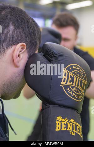 Man wearing BenLee boxing gloves concentrates during training, boxing TSV Calw, Germany Stock Photo