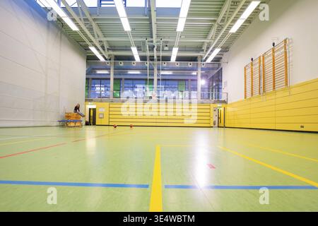 Empty sports hall with yellow walls and lines on the floor, basketball TSV Calw, Germany Stock Photo