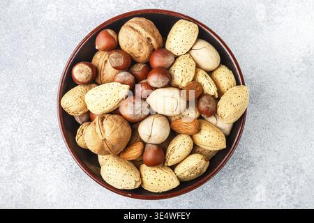 Food, Tasty and healthy assorted nuts in the peel-almonds, hazelnuts, pecans, walnuts. Gourmet snack. Healthy food. Selective focus Stock Photo