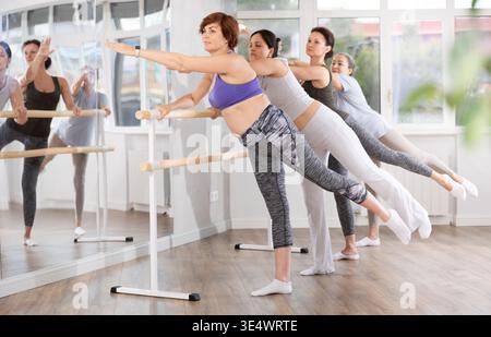 Group of women beginners practicing at ballet barre Stock Photo