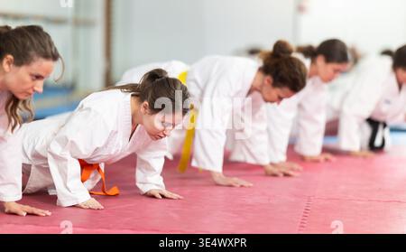 Women doing push-ups in training Stock Photo