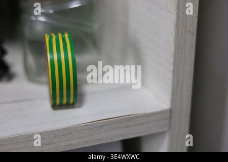 Electrical tape, yellow and green color, electrician equipment Stock Photo