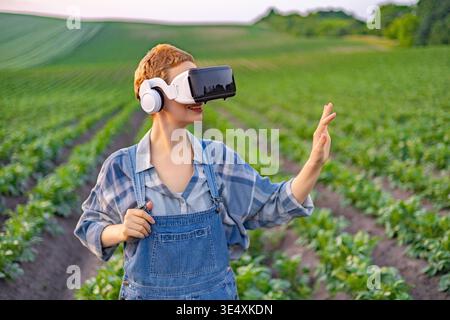 Farmer Using VR Headset in Field Stock Photo