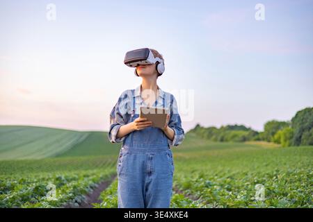 Farmer Using VR Headset in Field Stock Photo