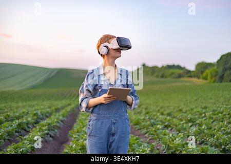 Farmer Using VR Headset in Field Stock Photo