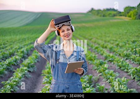 Farmer Using VR Headset in Field Stock Photo