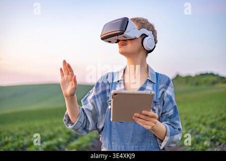 Farmer Using VR Headset in Field Stock Photo