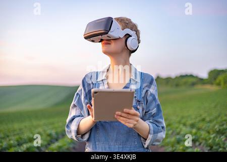 Farmer Using VR Headset in Field Stock Photo