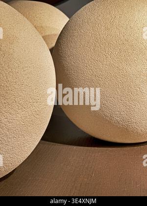 Abstract view of light and shadows falling on several clay balls on a shelf. Stock Photo
